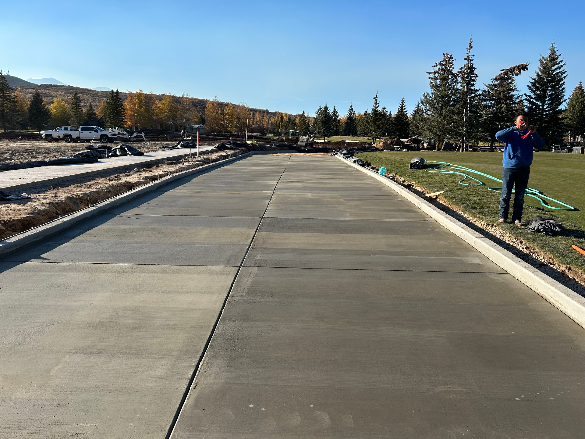 Long broom finished concrete driveway with mountain views in Utah
