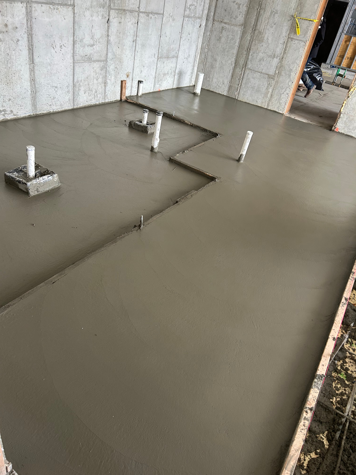 Smooth troweled commercial basement slab with plumbing penetrations