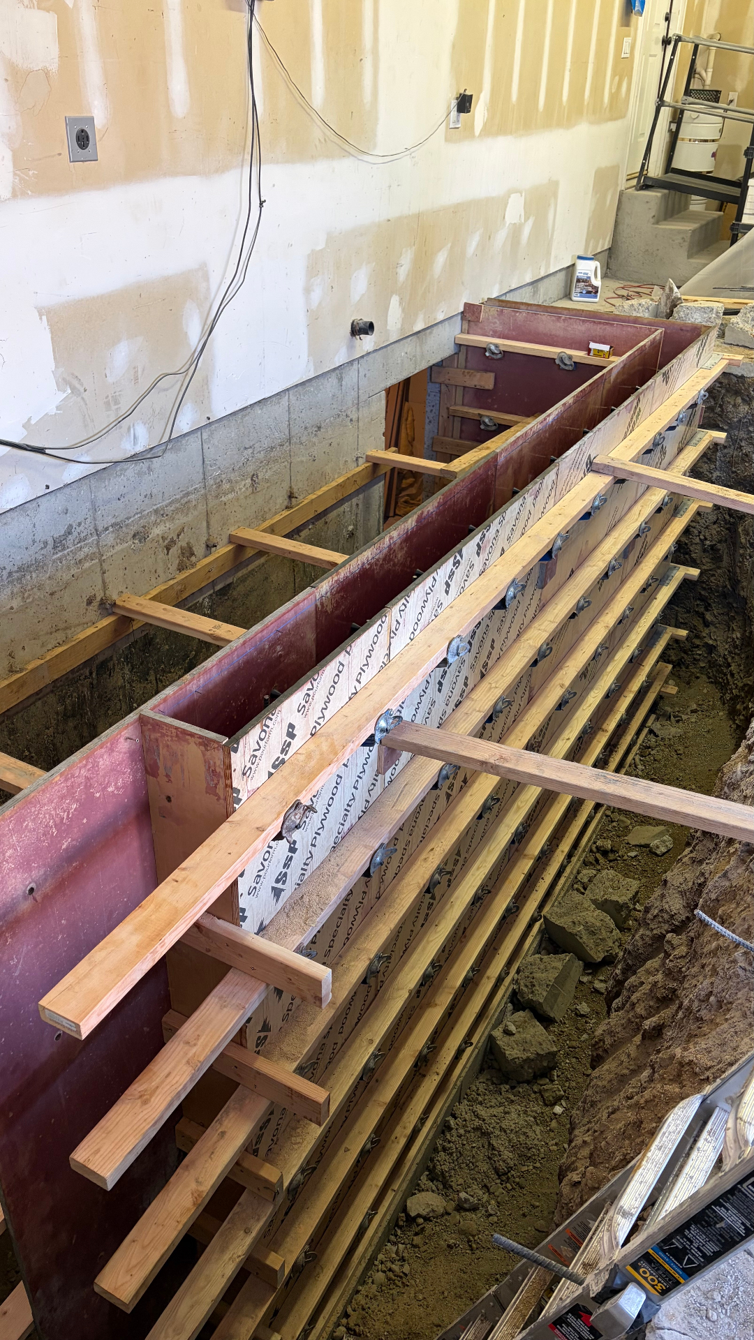 Foundation footing form work for poured concrete wall